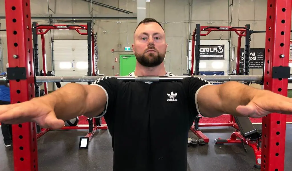 Walk into barbell with arms straight