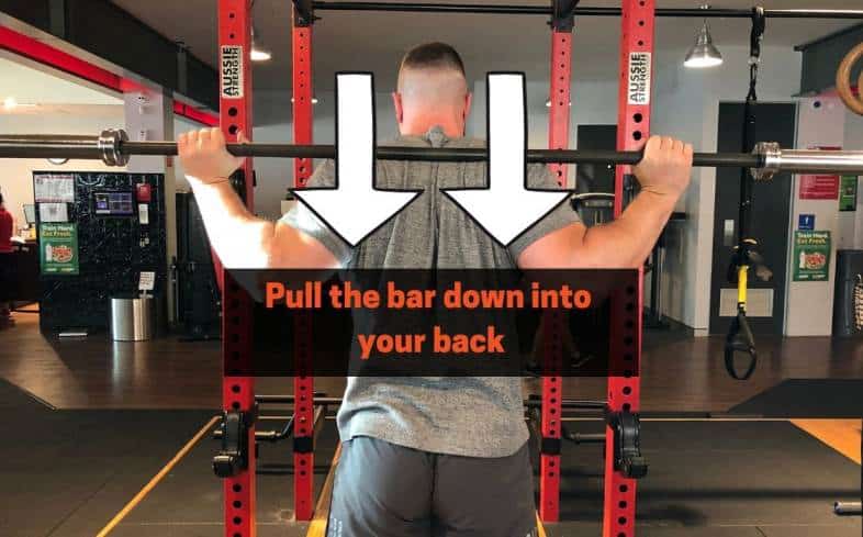 squat cue pull the bar down into your back