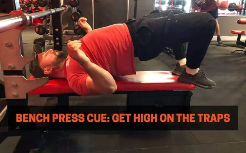 Bench press cue showing getting high on the traps