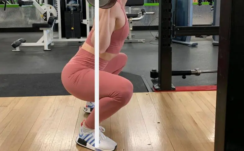 knees bending forward in ass to grass squat