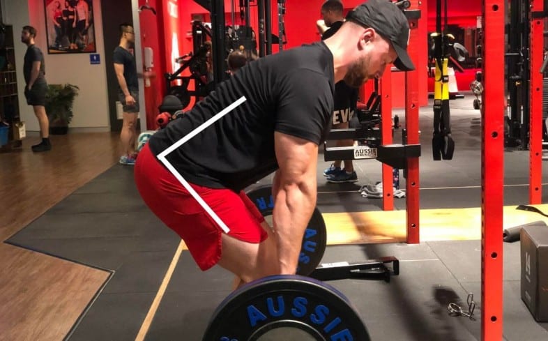 Demonstrating that the low back and pelvis are neutral (straight) while deadlifting