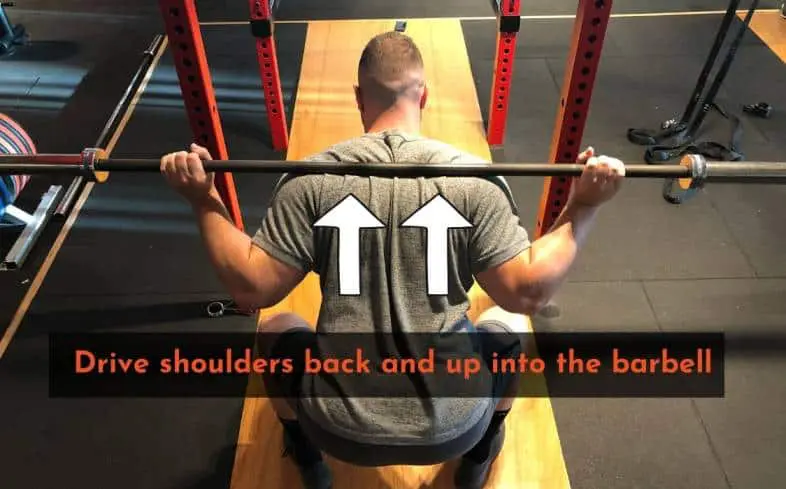 Use the squat cue drive the shoulders back and up into the barbell to help maintain an optimal torso position.
