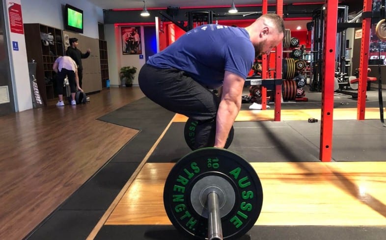 deadlifting with short arms may cause slightly round upper back