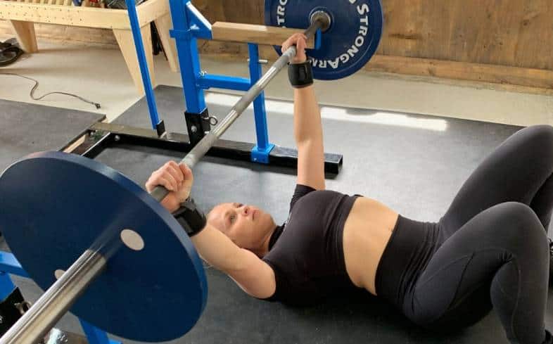 do the floor press with your legs bent and your feet flat on the floor