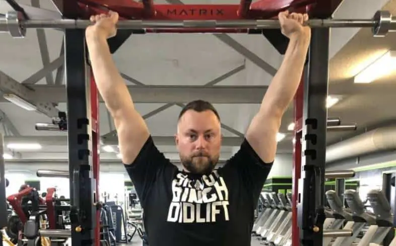 one of the best ways to build your shoulder strength is through the overhead barbell press