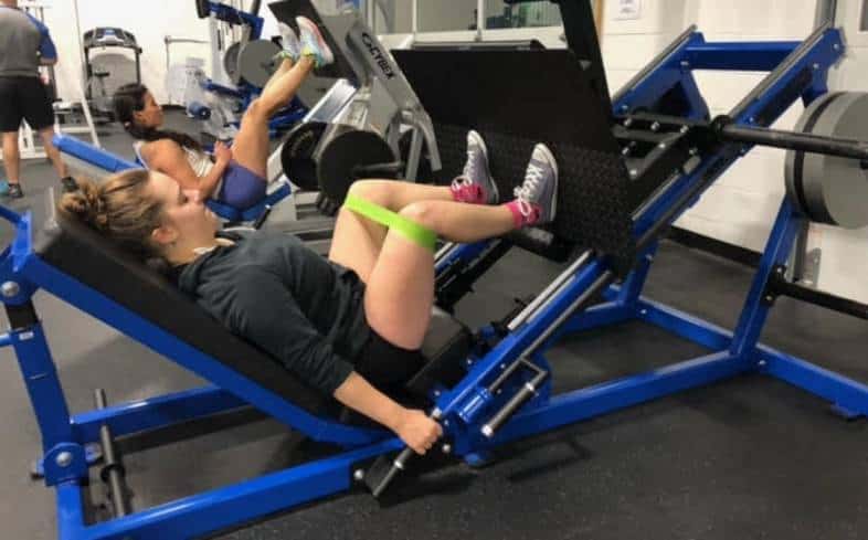 place a glute band around your knees to target your glutes more during the leg press