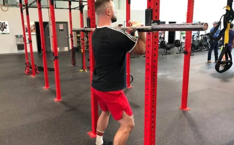 the bar should be placed on top of your shoulders