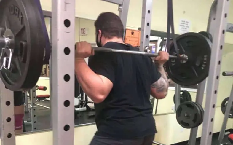 technique to perform a reverse band squat