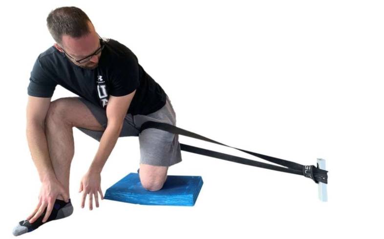 lateral capsule stretch using a heavy resistance band