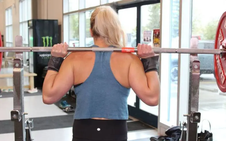 a regular grip is characterized by having four fingers wrapped around the barbell with the thumb tucked underneath the bar