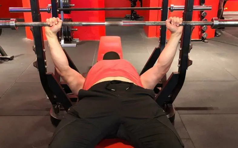 implementing a high-rep bench press into our training program can help us break through a plateau