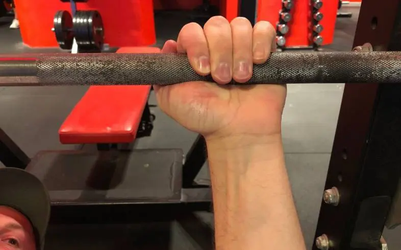 suicide grip can be useful in forcing you to tuck your elbows more on the bench press