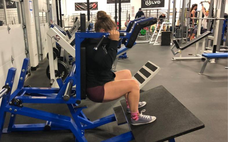 the hack squat is a machine-based compound exercise that targets the quads and glutes, and closely mimics the back squat due to the axial loading present 