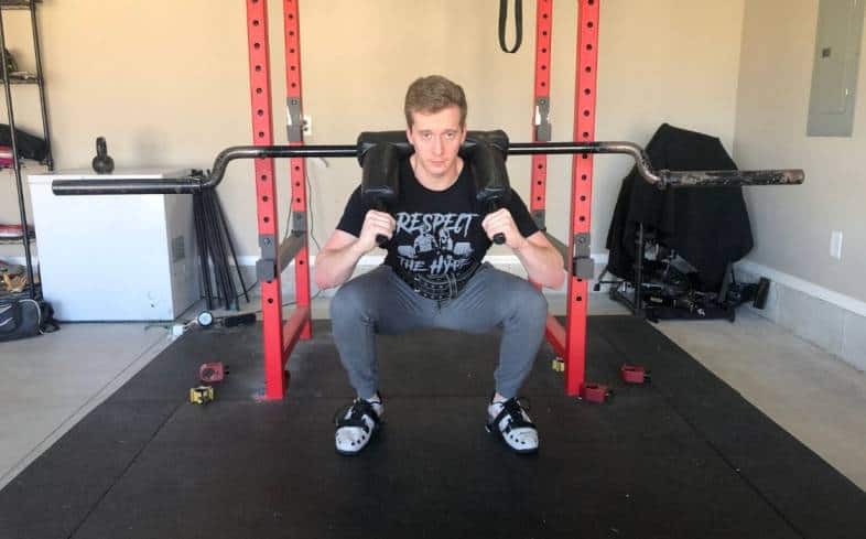 safety bar squats are performed using a specialty bar called a safety squat bar that has built-in shoulder pads and padded handles to hold