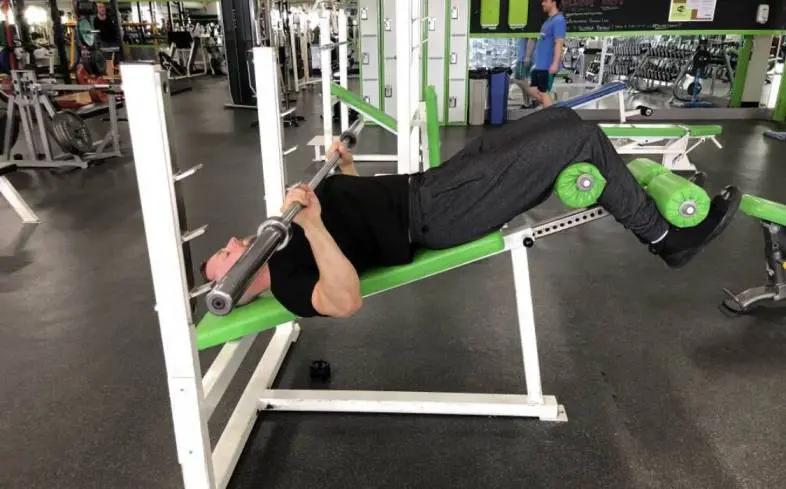 A professional powerlifting coach shows how to do decline bench press.