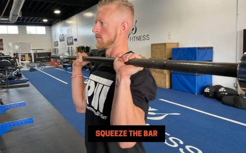 squeezing the bar hard in your hands prior to the un-rack will help stabilise your wrist position further