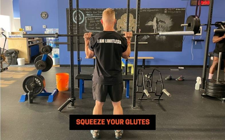squeeze your glutes help create a more stable base to press from and prevents you from arching your lower back