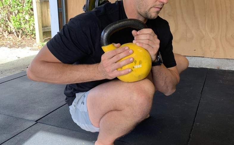 lifters holding additional weight in his hand or on his thigh over the joint for an increased stretch. 