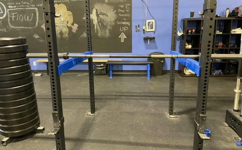 How To Do The Anderson Squat Step : Set the safety pins in a squat rack
