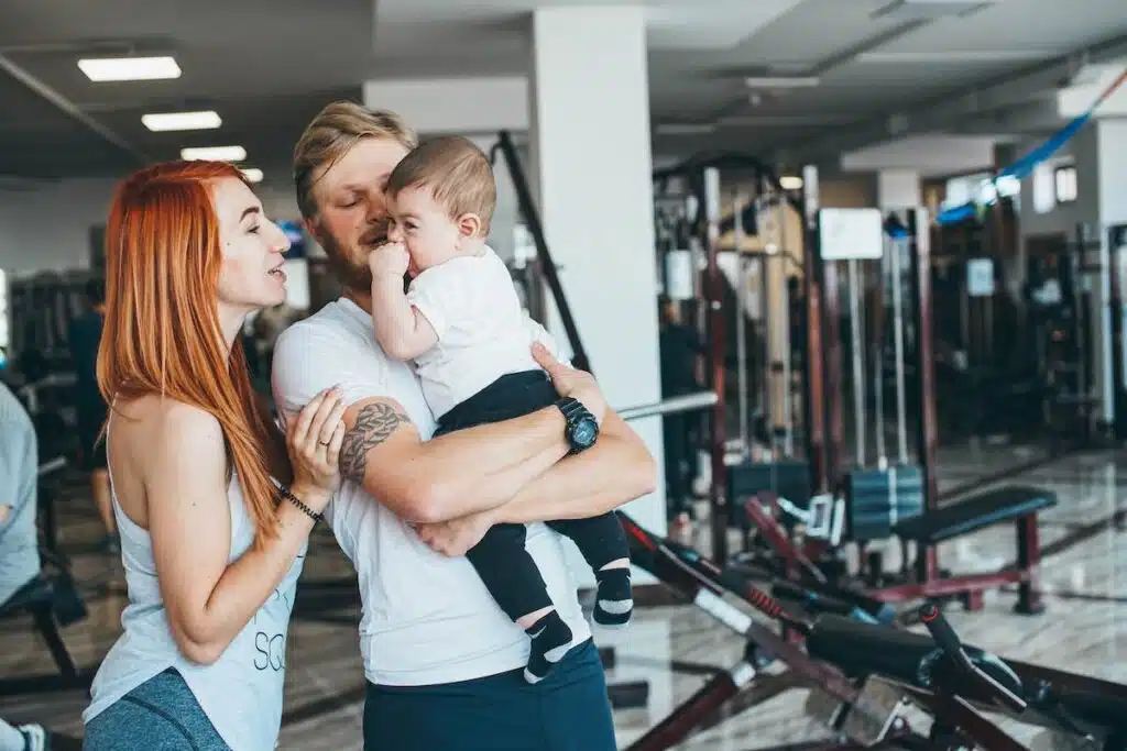Young family with little boy in the gym