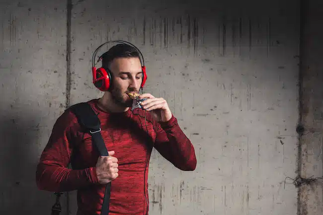 Athele eating protein bar