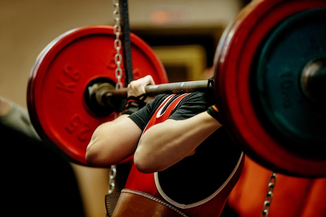 female powerlifter squat barbell