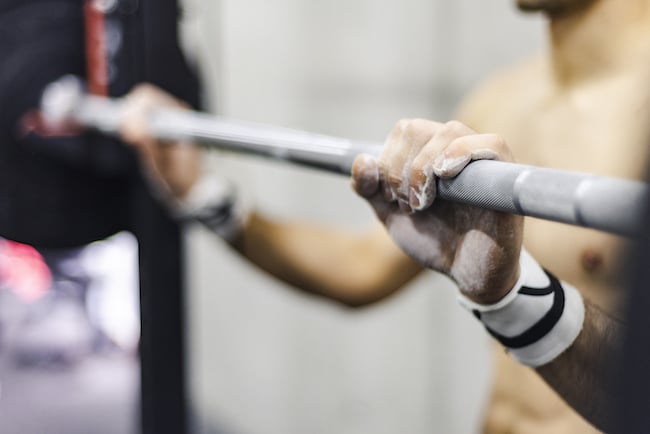 Man training with barbell in gym