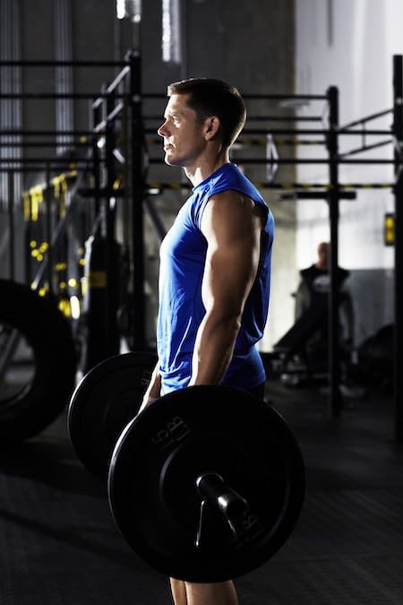 Man with barbell in a gym