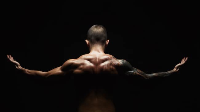 Unrecognizable man shows strong neck muscles closeup