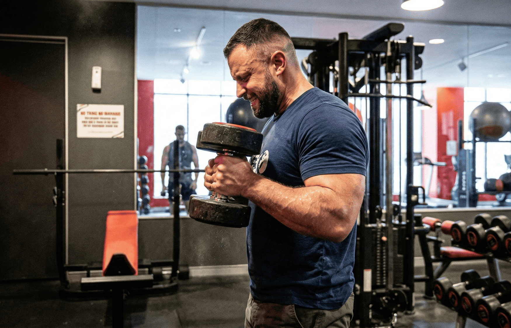 A powerlifter doing bicep curls at the gym.