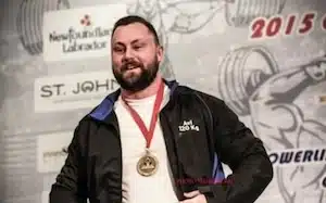 avi silverberg official head shot head coach team canada powerlifting receiving a powerlifting medal
