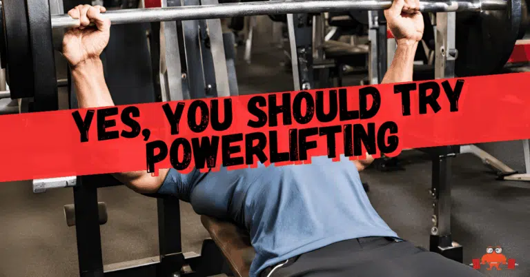 A person bench presses at the gym. They're learning to powerlift.