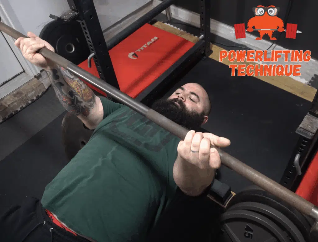 A powerlifting coach shows how to do the reverse band bench press.