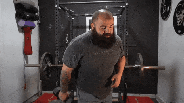 Fitness coach shows how to do cheat curls.