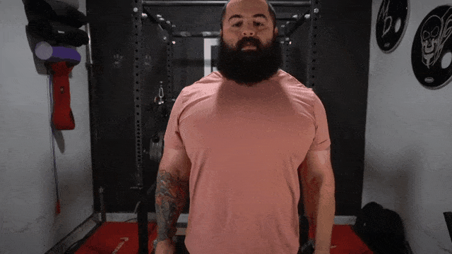 A fitness coach shows how to do the dumbbell squat properly.