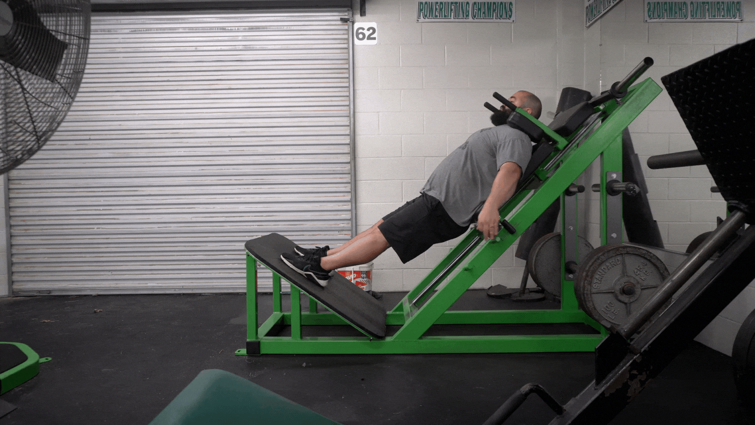A professional strength coach shows how to do hack squats.