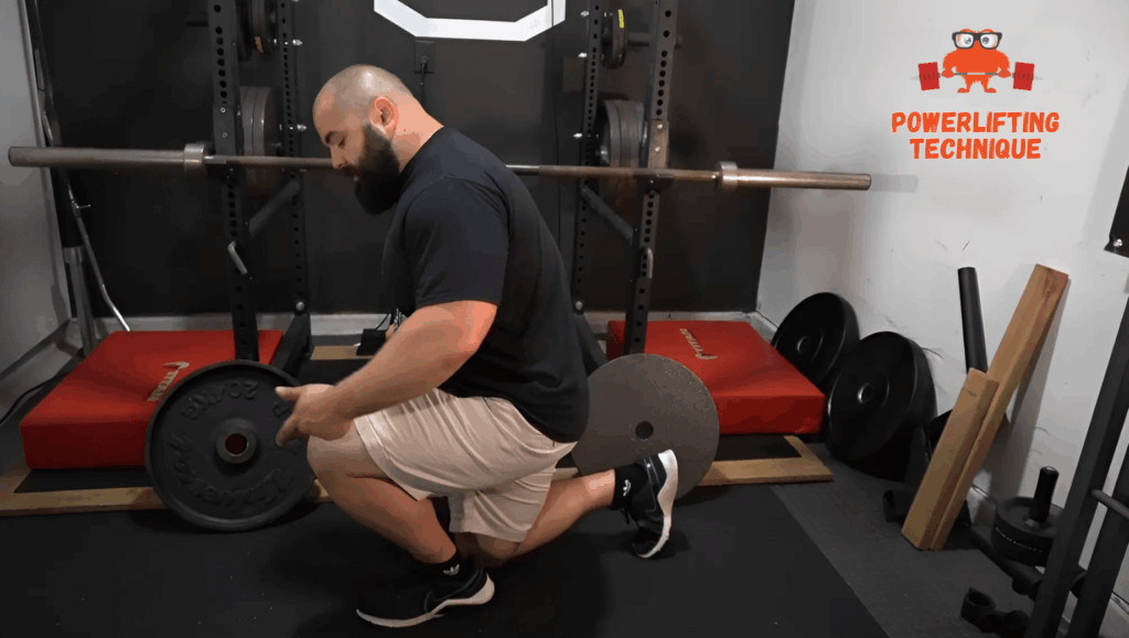 A professional strength coach shows the narrow stance for split squats.