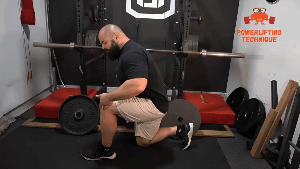 A professional strength coach shows the wide stance for split squats.