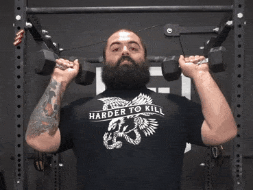 A strength coach shows dumbbell overhead press as an alternative to barbell overhead press.