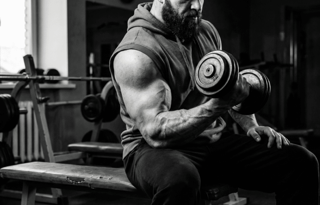 A powerlifter doing bicep curls at the gym.