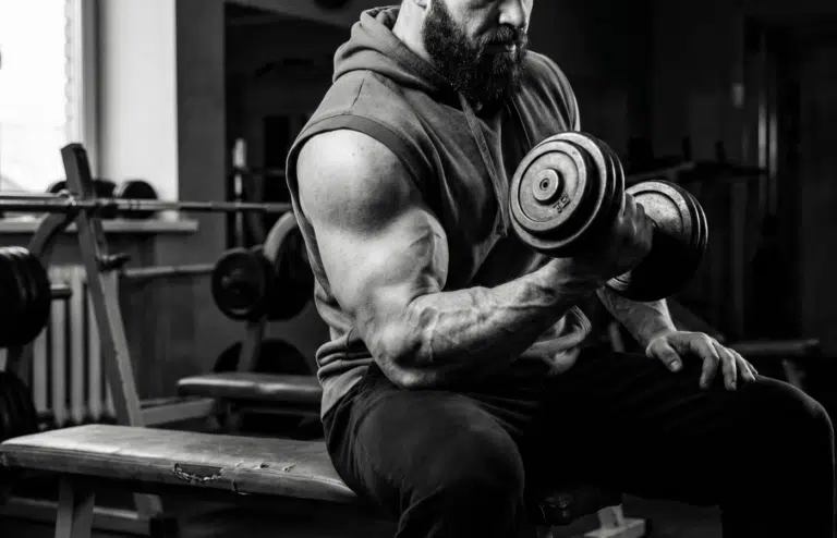 A powerlifter doing bicep curls at the gym.